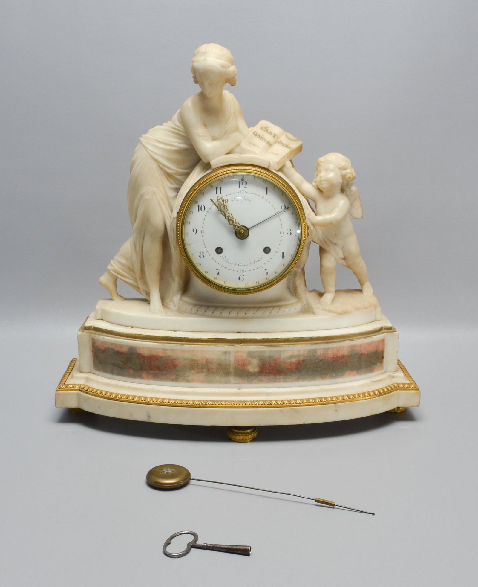 Figural White Marble FL Godon French Shelf Clock: Figural White Marble FL Godon French Shelf Clock, white enamel dial with calendar dial, bell striking on half hour and hour, signed "F.L. Godon, Reloxero de Camera de S.M.C." (Clockmaker to the Chambe