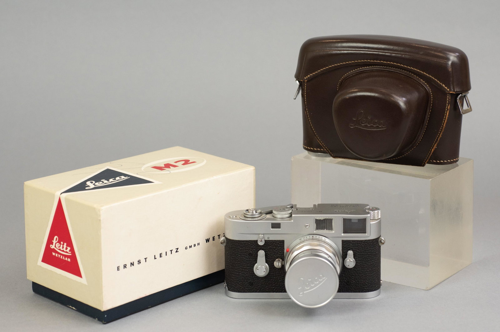 Leica M2 35mm Rangefinder with Summicron 50mm 1:2 lens: Leica M2 with Summicron 50mm 1:2 rigid lens with original box and leather carry case. The camera, serial number 1,068,437, is in very good cosmetic condition, a small indentation on the top plate abov