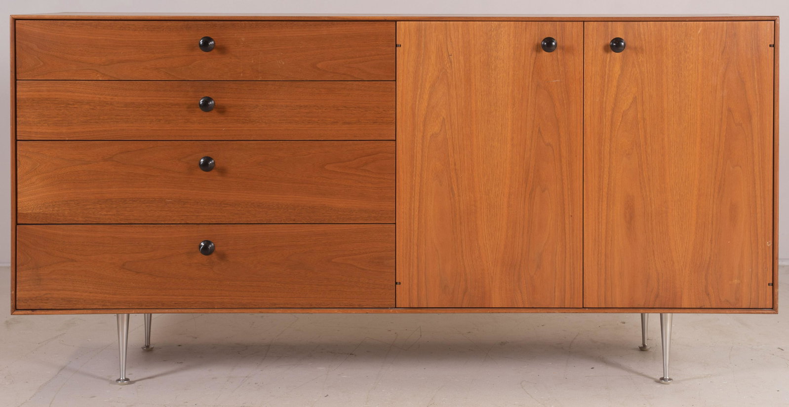 George Nelson for Herman Miller walnut credenza: George Nelson for Herman Miller walnut credenza, chrome feet, two doors flanked by 4 drawers, 33-1/4"h x 67-1/2"w, wear to finish