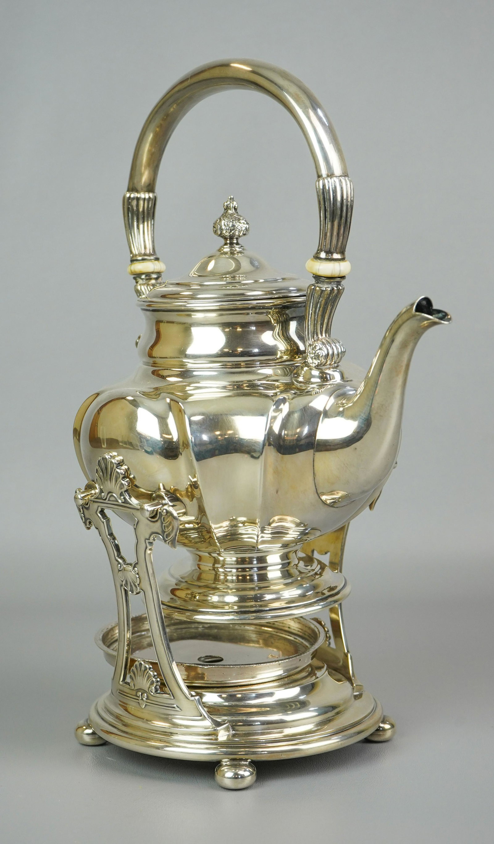 Sterling RW&S Tilting Teapot: Sterling RW&S tilting teapot to include sterling footed gourd form teapot with handle, gadrooned joined, with bone fittings, affixed at sides for stand, 29.8 T.O, with silver plated lid and silver pla