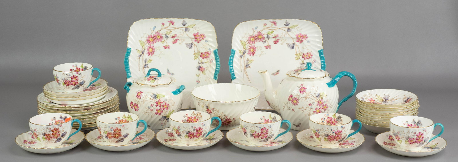 (42) Pcs Spode Luncheon Set: (42) Pcs Spode porcelain luncheon set, pink floral with turquoise ribbon accents, c/o (9) 7" dessert plates, (11) 5-1/4" fruit bowls, (7) teacups, (10) saucers, round waste bowl, 2 cake dishes, teapot
