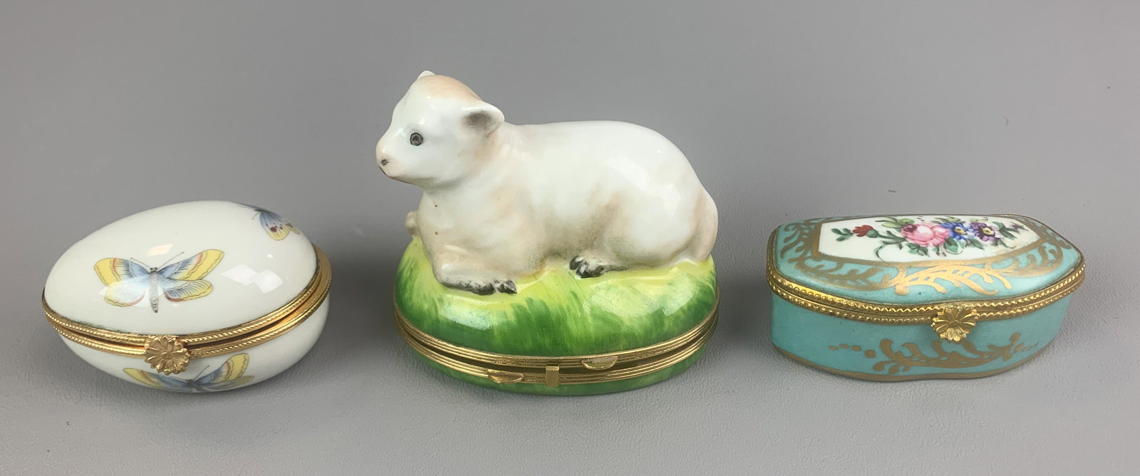 (3) Limoges Porcelain Trinket Boxes: (3) Limoges porcelain trinket boxes, c/o figural lamb, egg shaped with butterfly decoration, asymmetrical with hand painted floral decoration, largest 3-1/4" w x 2-3/4" h