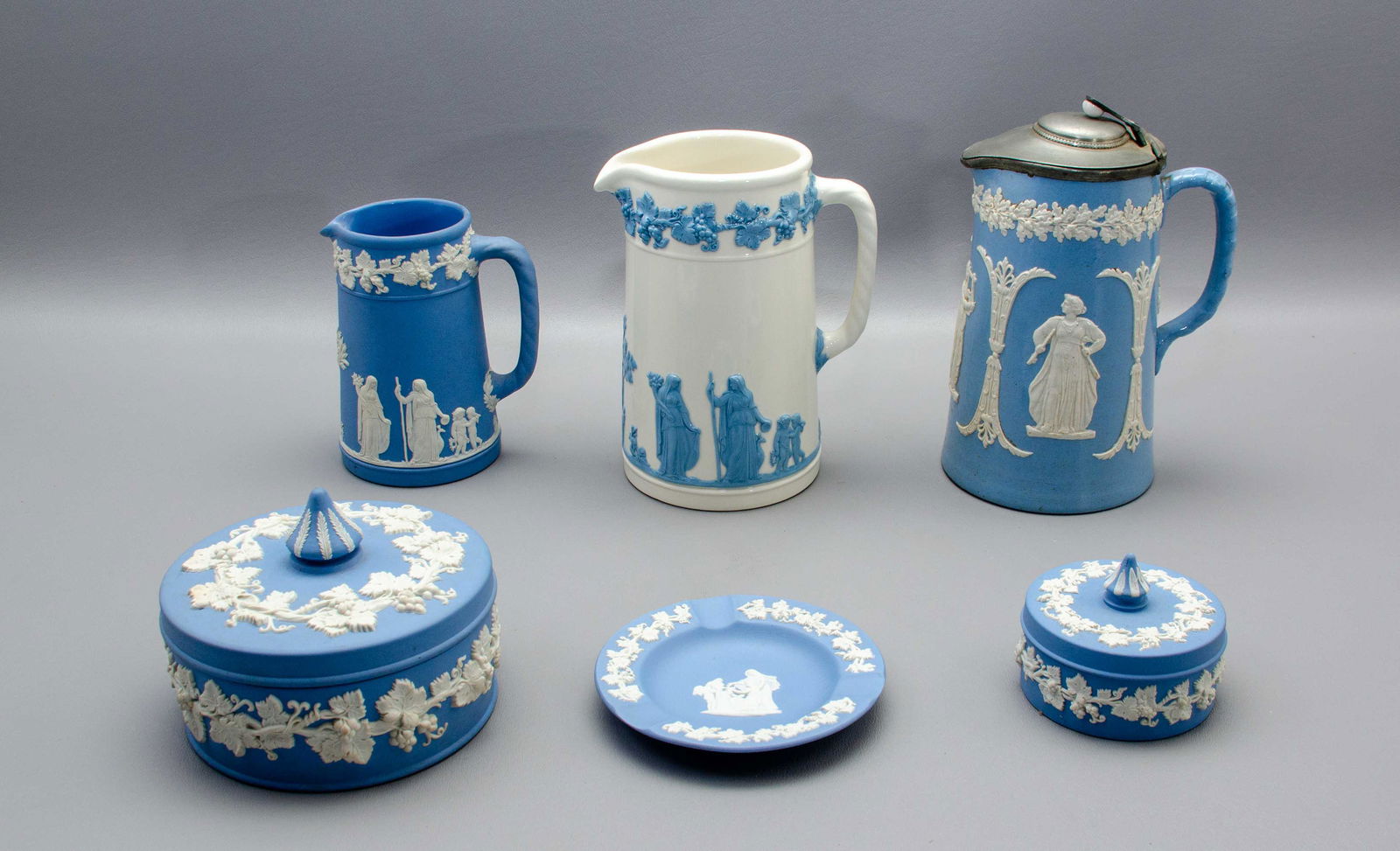 (6) Pcs Wedgwood and Dudson Table Items: (6) Pcs Wedgwood and Dudson table items to include Wedgwood jasperware pitcher, 5-1/8" h, trinket box, 3-1/8" diam, ash tray, 4-1/2", oversized dresser box, 5" diam, Queensware pitcher, 6-1/2" h and D