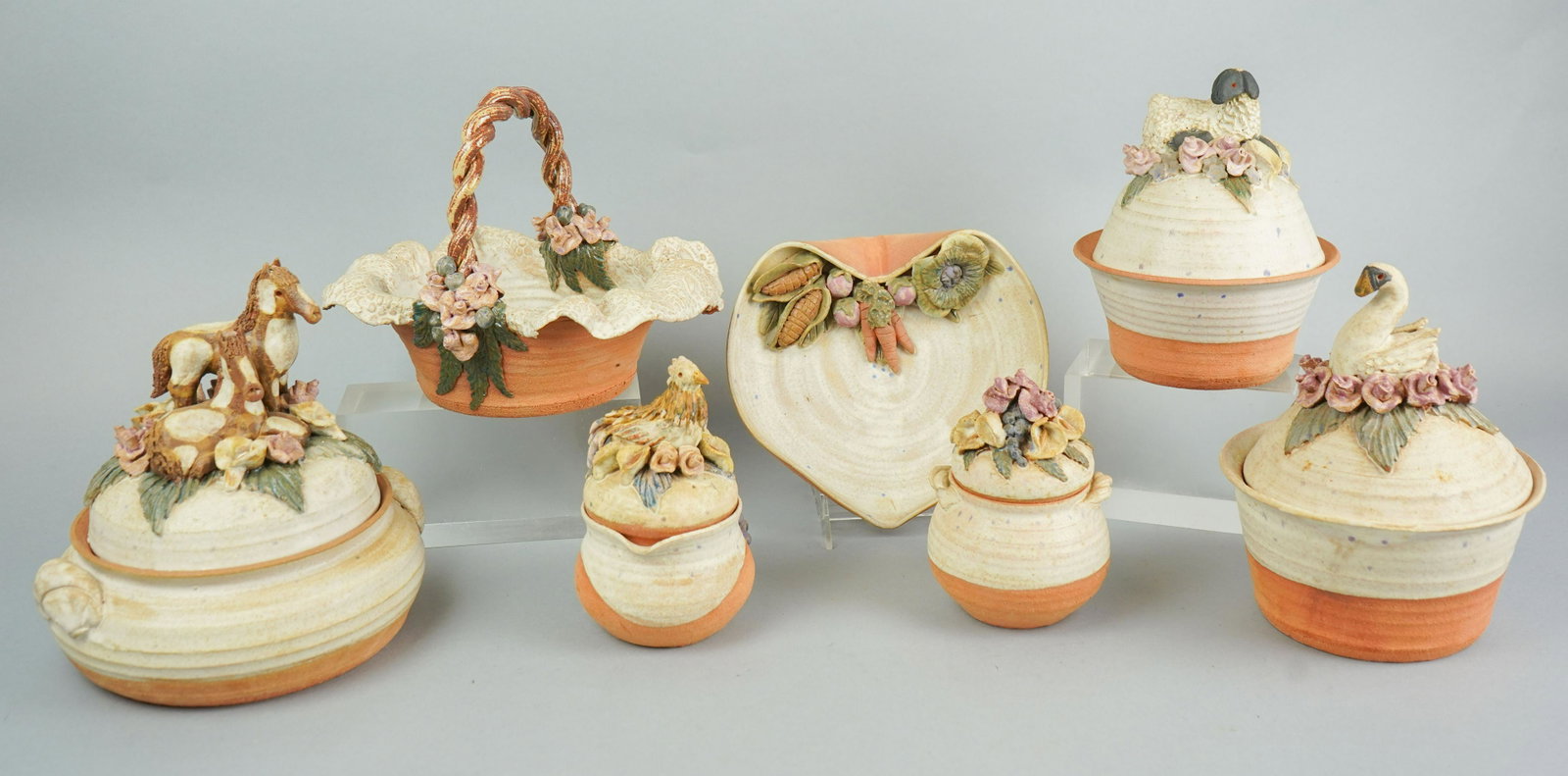 (7) Pcs Sandra McKenzie Schmitt Pottery: (7) Pcs Sandra McKenzie Schmitt pottery, c/o casserole with horses lid, bowl with lamb lid, bowl with swan lid, basket, dish with vegetables, sugar bowl with flower lid, creamer with hen lid, tallest 