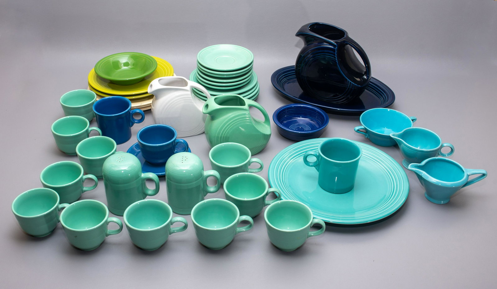 (40 +1) Pcs Homer Laughlin Fiesta dinnerware: (40 +1) Pcs Homer Laughlin Fiesta dinnerware, including plates, cups, saucers, mug, pitchers, creamer one Fiesta style, bowls, covered casserole, tray, one broken t-cup