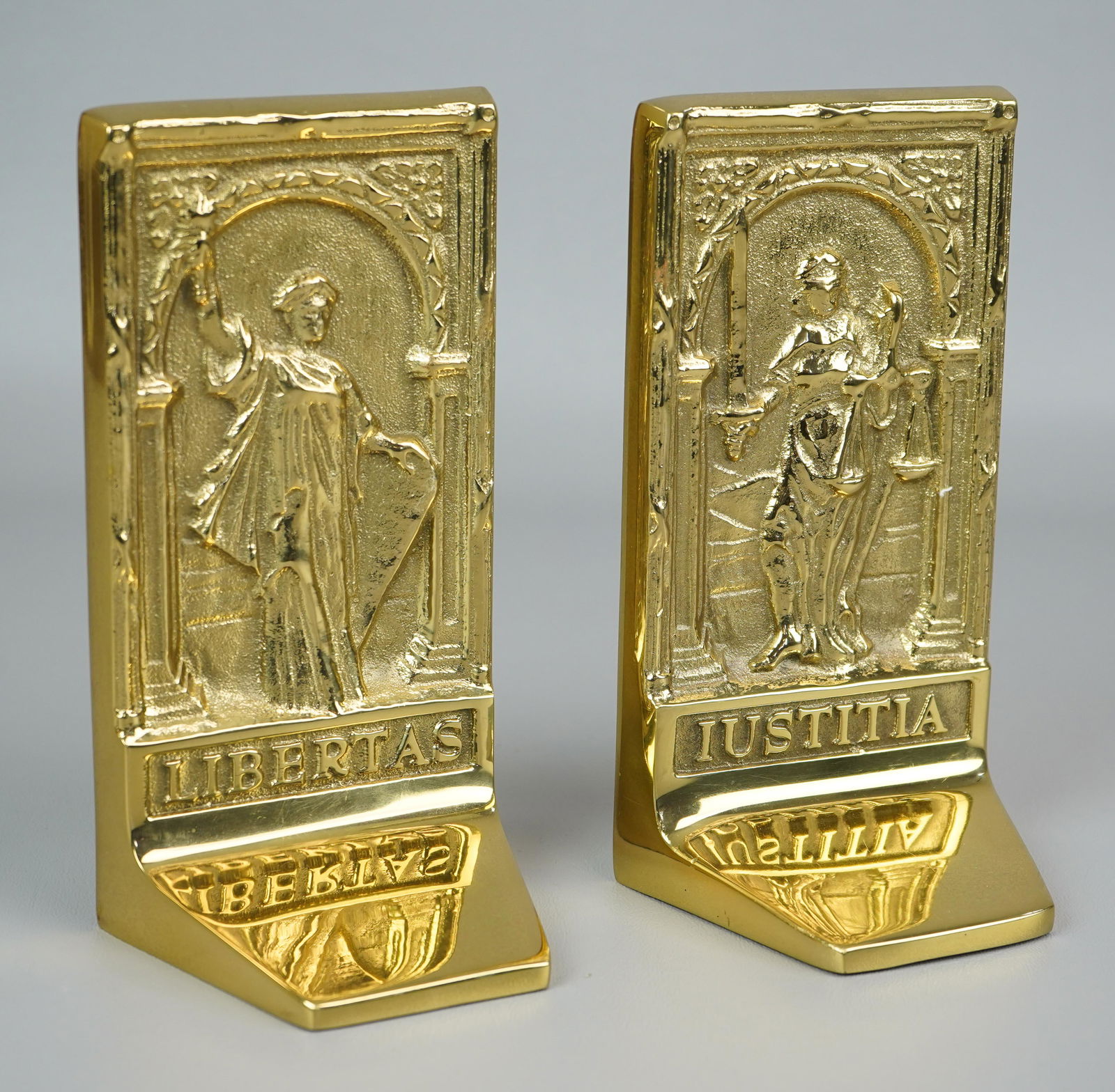 Virginia Metalcrafters Brass Bookends: Virginia Metalcrafters Liberty & Justice heavy solid brass bookends, embossed portraits of Libertas & Justitia, quotes from Aristotle & Thomas Jefferson on back, 7" h x 3-3/4" w