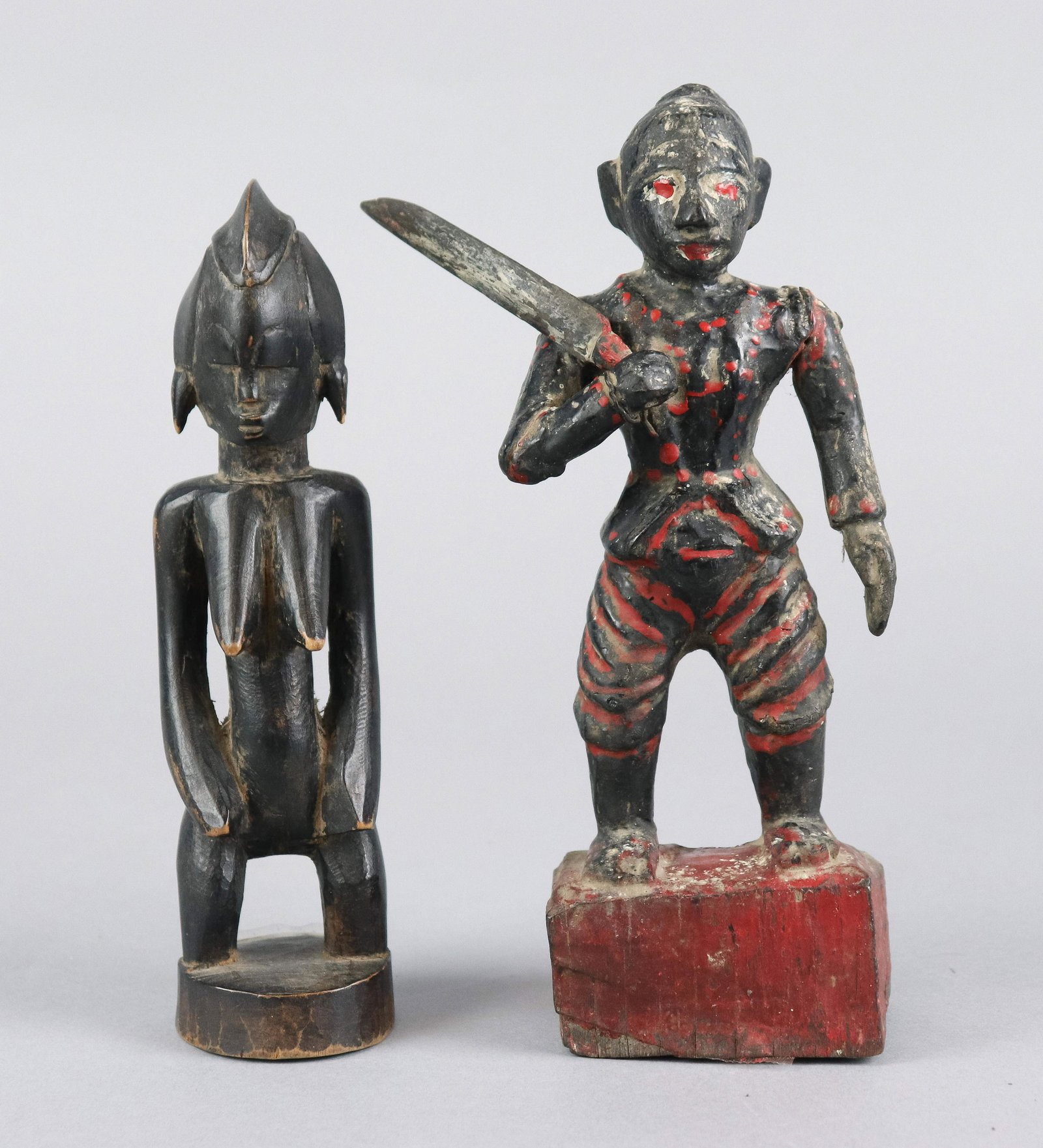 (2) African Carved Wood Statues: (2) African carved wood miniature statues, c/o Senufo woman, Thai painted man with machete, tallest 8-3/4"
