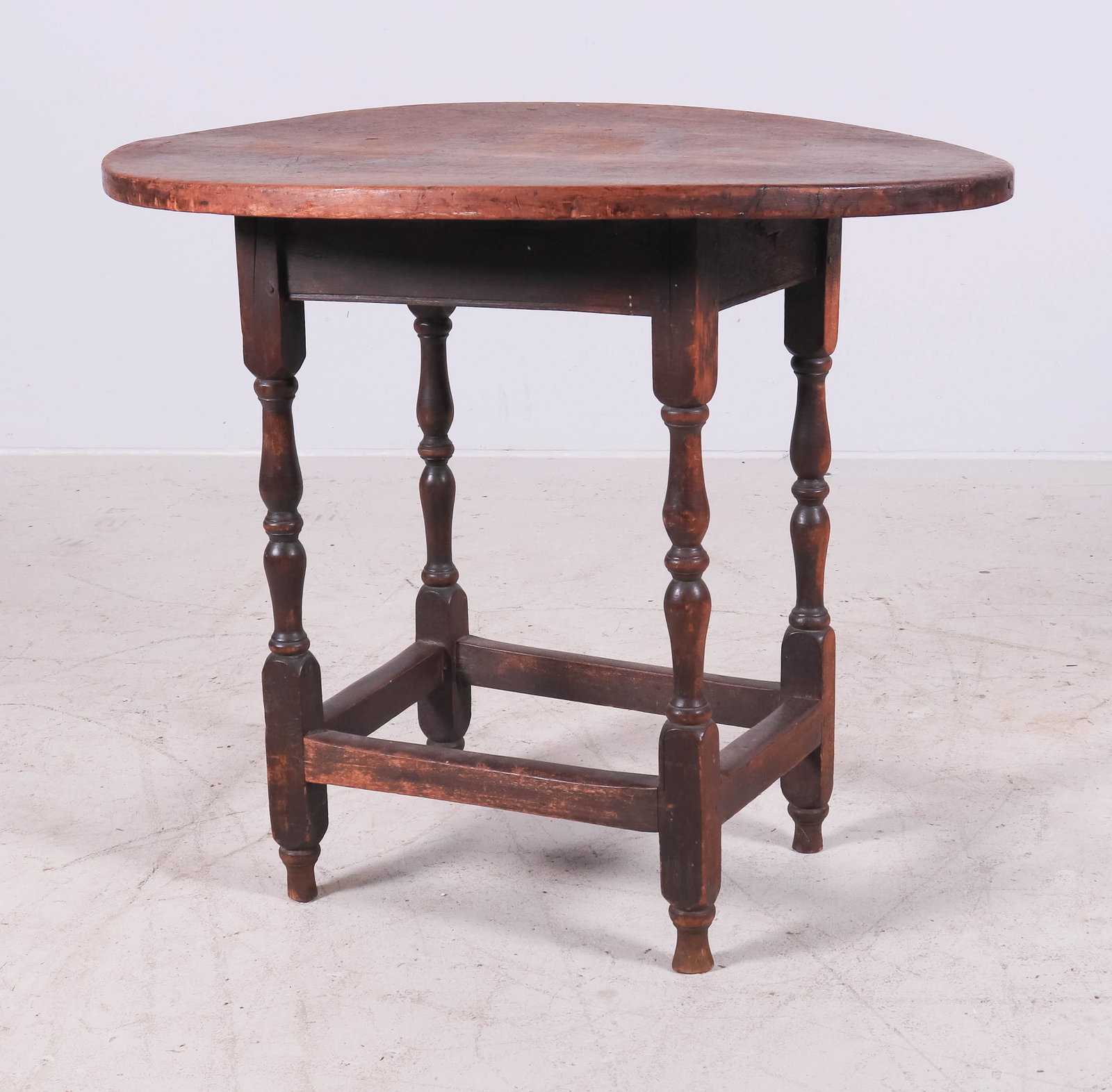 New England oval maple or birch stretcher base table: New England oval maple or birch stretcher base table, double baluster turned legs with outside stretcher base, oval two board top, old brown painted finish, New England early 18th c, 30-3/4" x 23-1/2"