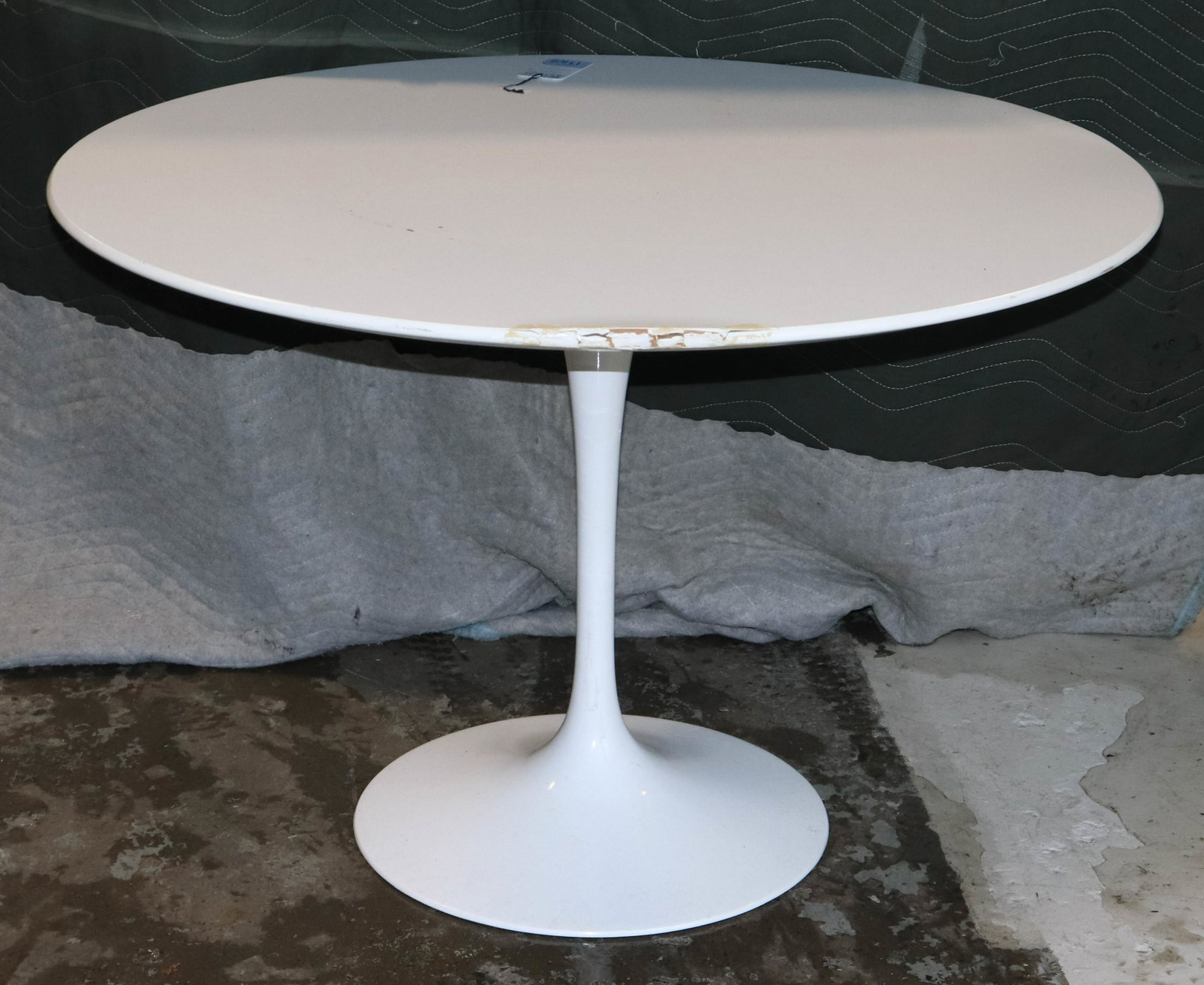 Knoll "Tulip" table: Eero Saarinen for Knoll "Tulip" table, white laminate top with white metal base, 29" h x 42-1/2" diameter, wear to edge of table top