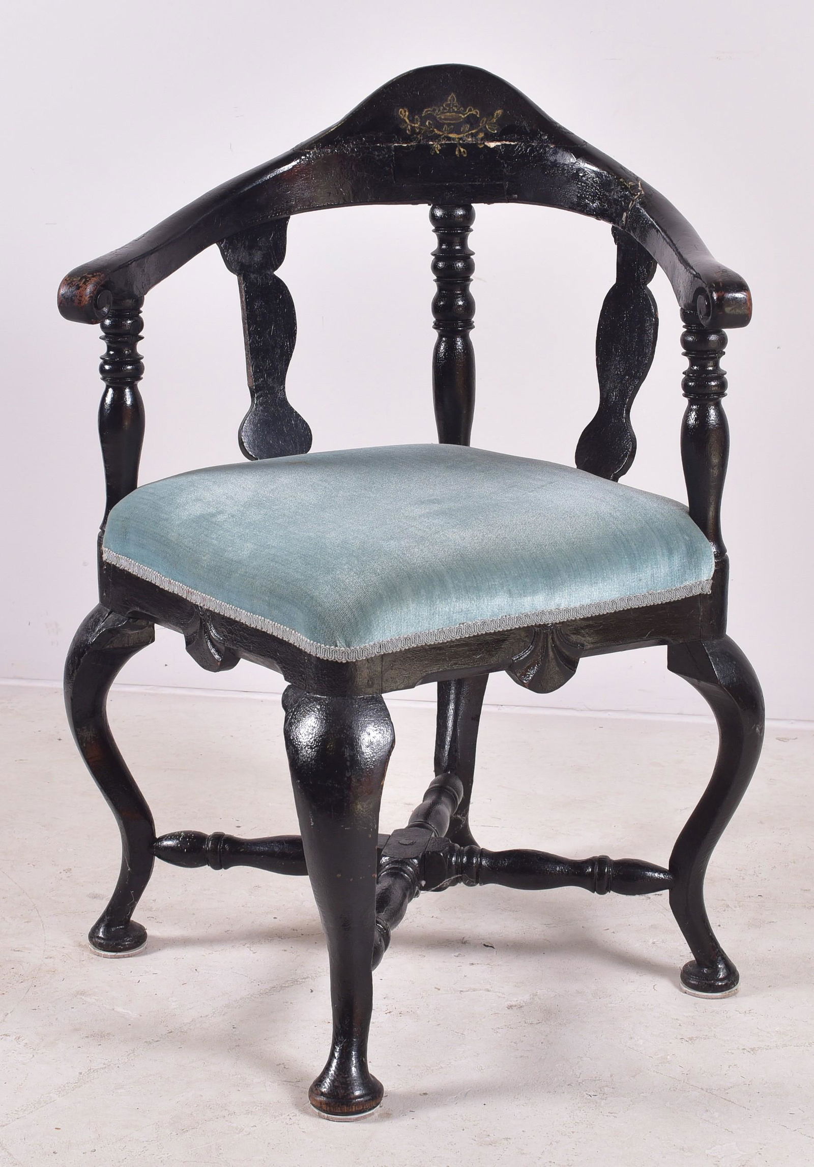 Continental Queen Anne roundabout corner chair: Continental Queen Anne roundabout corner chair, turned posts supporting scrolled arms and a high crest rail, the apron with carved shells, all raised on a cabriole leg cross stretcher base, repairs an