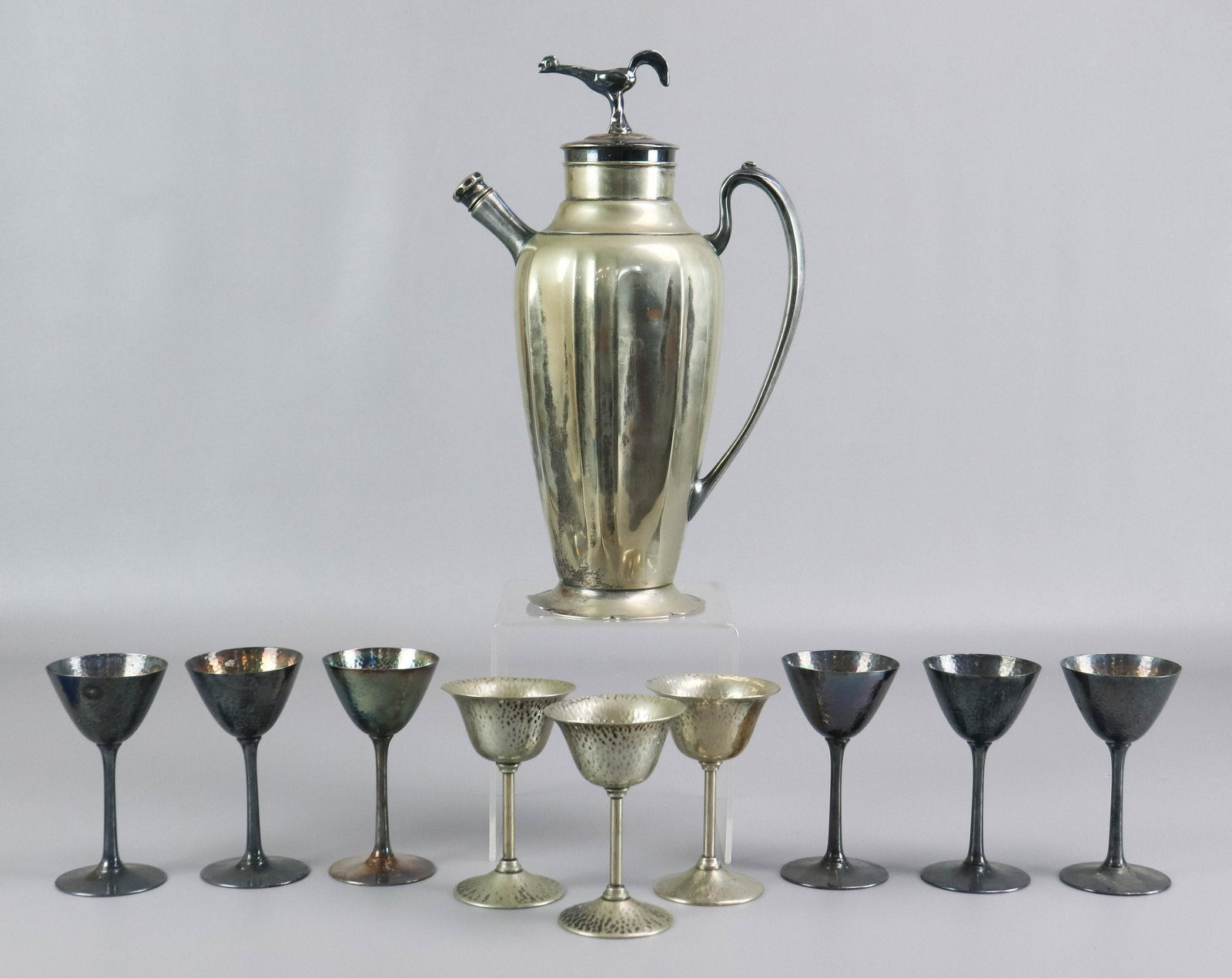 Bernard Rice's Sons Inc. Shaker and Cups: Bernard Rice's Sons Inc. shaker and cups, 1920's, rooster topped stopper, does not fit completely, (6) Meriden silverplate hammered cups and (3) Bernard Rice's Sons Inc. hammered cups.