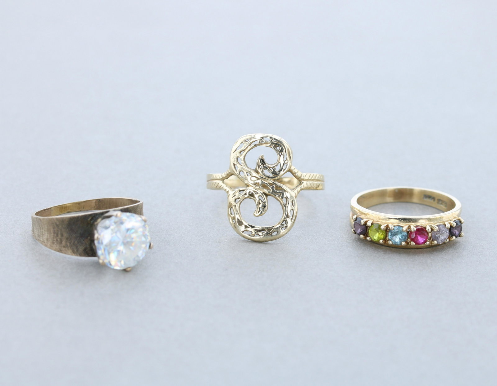 (3) 14K Yellow Gold Ladies Rings: (3) marked 14K yellow gold ladies rings C/O; (1) six stone ring, marked 14K sz.9, (1) marked 14K S initial ring, sz.12. the shank is bent, (1) marked 14K yellow gold vintage ladies ring with one 10.3m