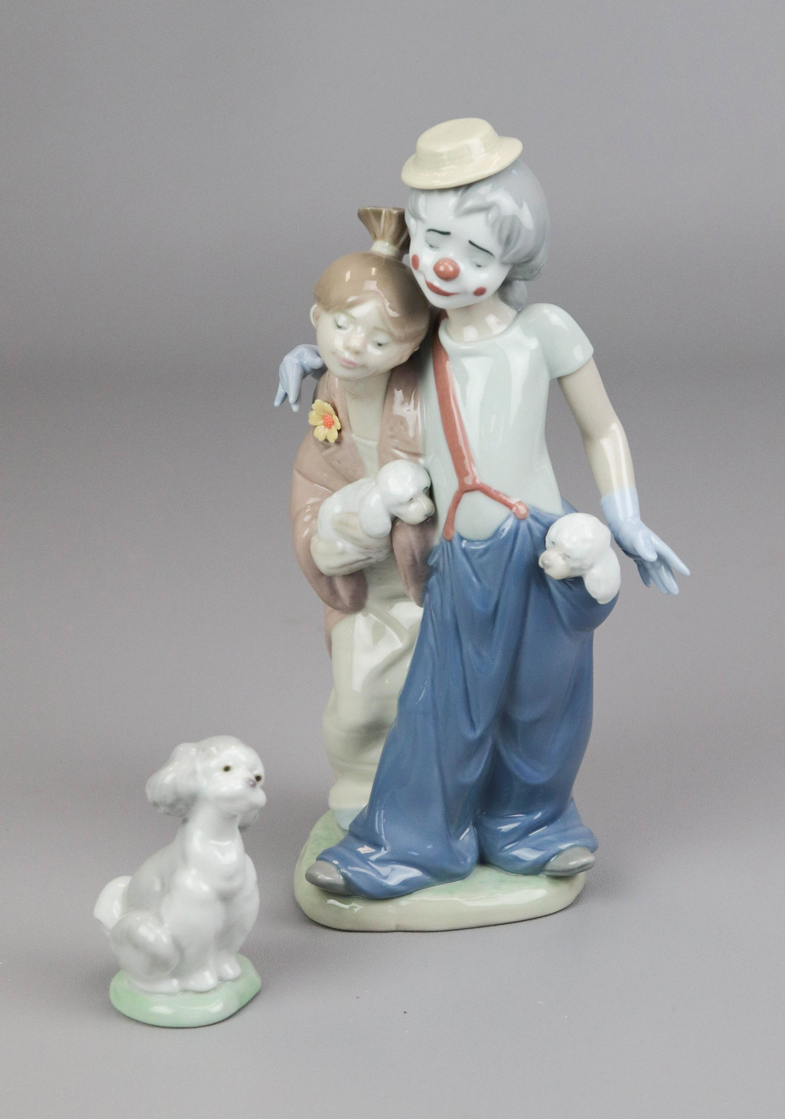 (2) Circus Theme Lladro Figures: (2) Lladro porcelain figurines, c/o "Pals Forever" depicting circus clowns, No 7686, 8-3/4" h, and "A Friend for Life" seated dog, No 7685, 3" h, with original boxes
