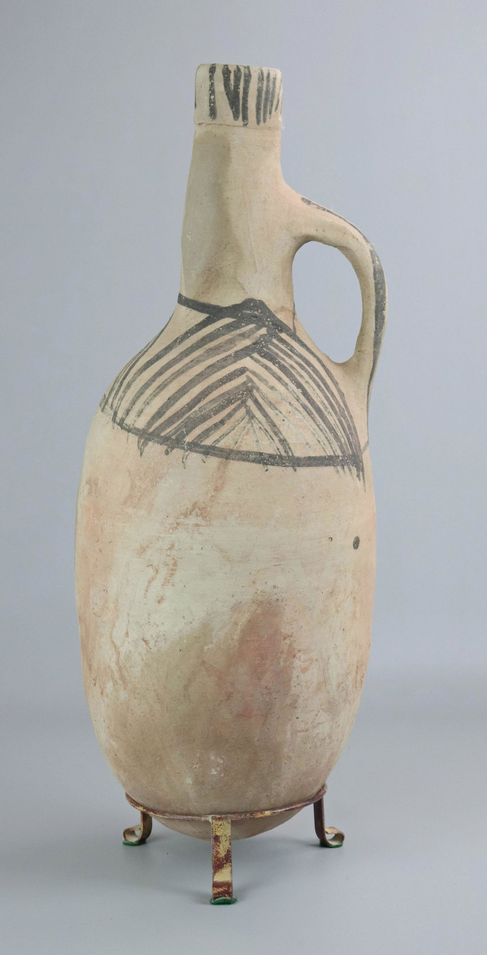 Redware Pottery Jug: Redware pottery jug, one handle, primitive hand painted decoration, rounded base, on metal tripod stand, 24-1/2" h