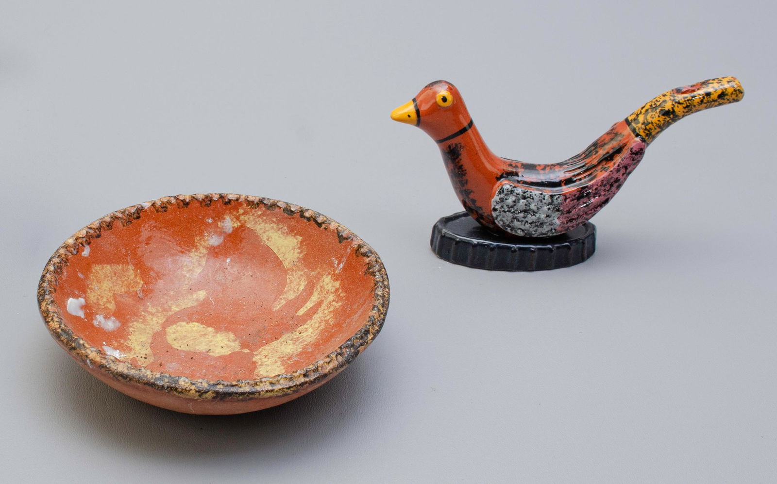 (2) Pcs Redware: (2) Pcs redware to include James Seagreaves JCS signed sponge glazed bird whistle, 7-1/4" l, and Susan Campbell Bryn Mawr signed bunny decorated dish, 6-1/2" dia