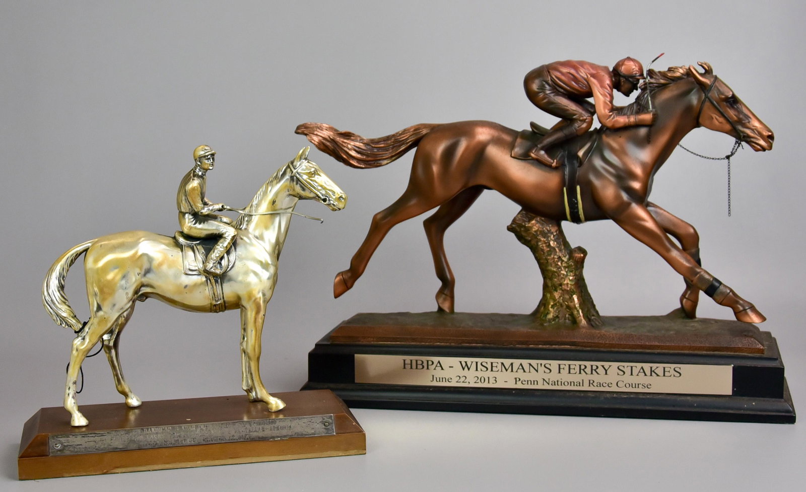 (2) Horse Racing Trophies: (2) Horse racing trophies, HBPA Wisemans Ferry Stakes, June 22, 2013, Penn National Race Course, molded resin horse and jockey with copper patina; Princeton Handicap 3 Year Old Fillies, -Six Furlongs,
