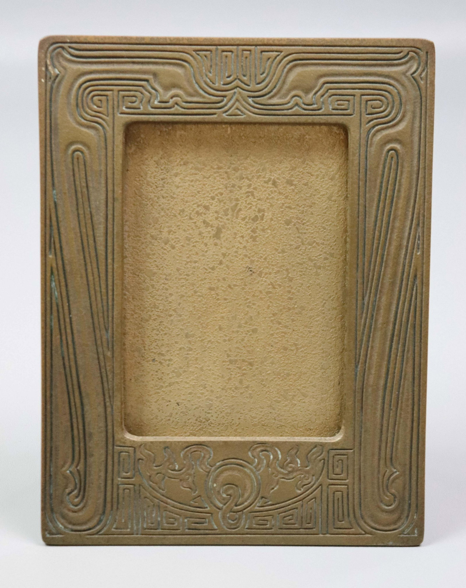 Tiffany Studios Chinese Pattern Picture Frame: Tiffany Studios Chinese pattern picture frame, bronze picture frame in Tiffanyâ€™s "Chinese" pattern, 5-1/2" h x 3-3/4" w interior; signed "Tiffany Studios New York, 1761", 8-1/2" h x 6-3/4" w.