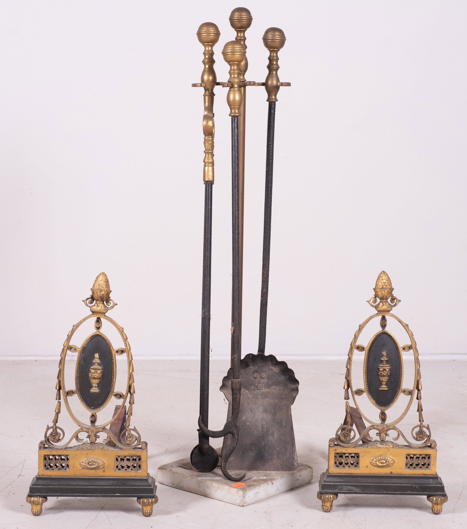Andirons and Fire Irons: Andirons and fire irons to include marble base stand with 3 brass handled fire tools and raised scroll, urn and gilt decorated andirons with artichoke finials.