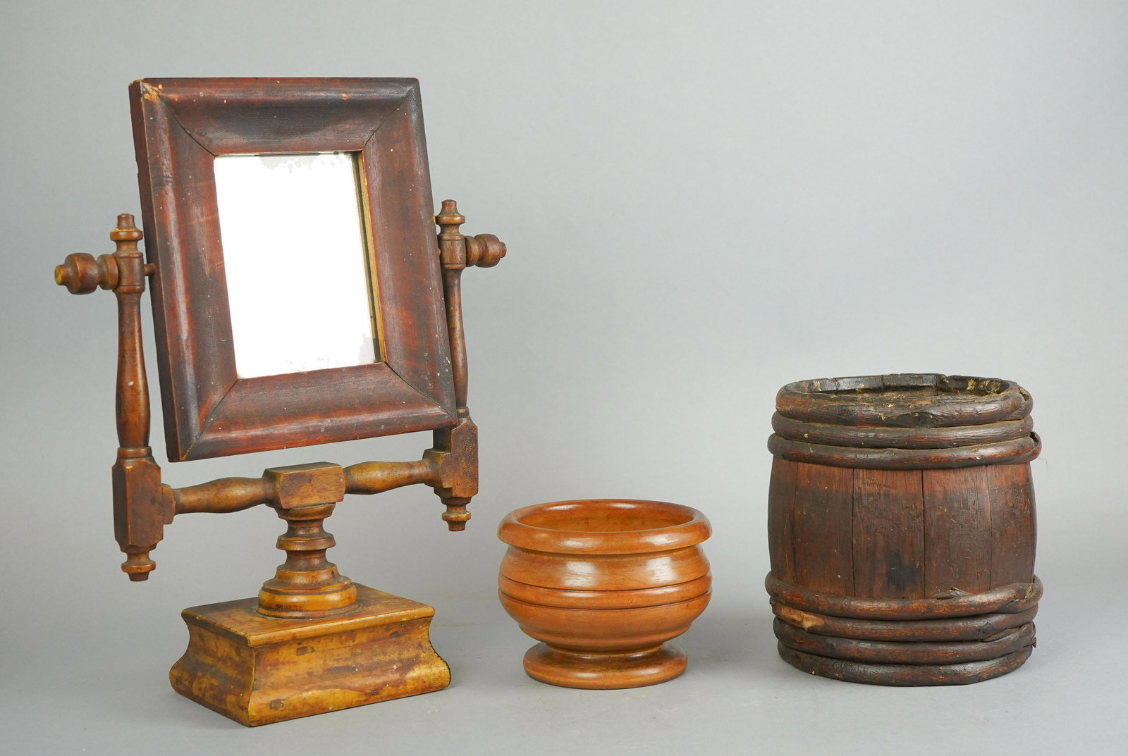 19th C. Shaving Mirror and Wood Vessels: 19th c. shaving mirror and wood vessels to include shaving mirror on stand with turned wood supports, signed underside illegibly and dated 1860, 15-3/4" H, vine wrapped open barrel, 7-1/2" H x 6" D an