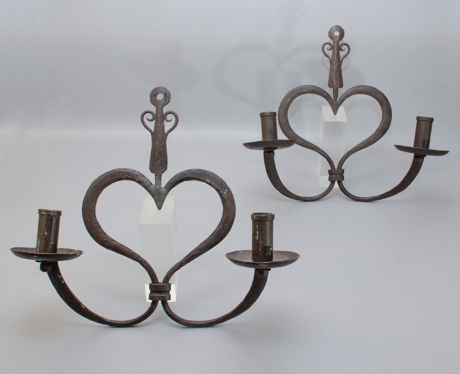 Pair Wrought Iron Double Arm Wall Sconces: Pair wrought iron double arm wall sconces, in heart form, with matched wrought bobeche and scroll details, 21" across, 19" high