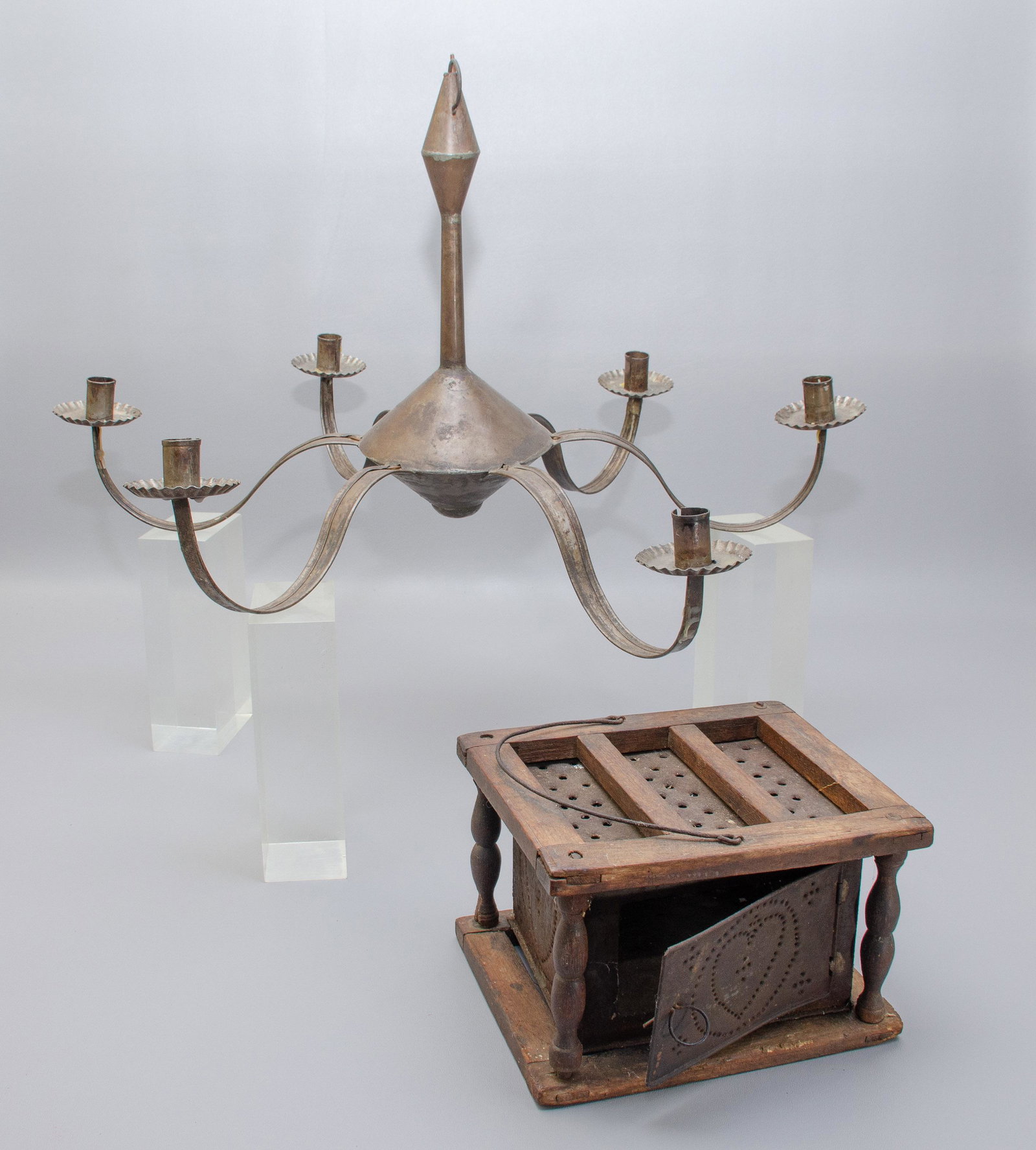 Punched Tin Foot Warmer and Hanging Candelabra: Punched Tin Foot Warmer and Hanging Candelabra to include heart shape punched tin box in wood surround with swing handle at top, 9"x6"x8" and hanging 6-arm tin candle chandelier with crimped bobeche, 