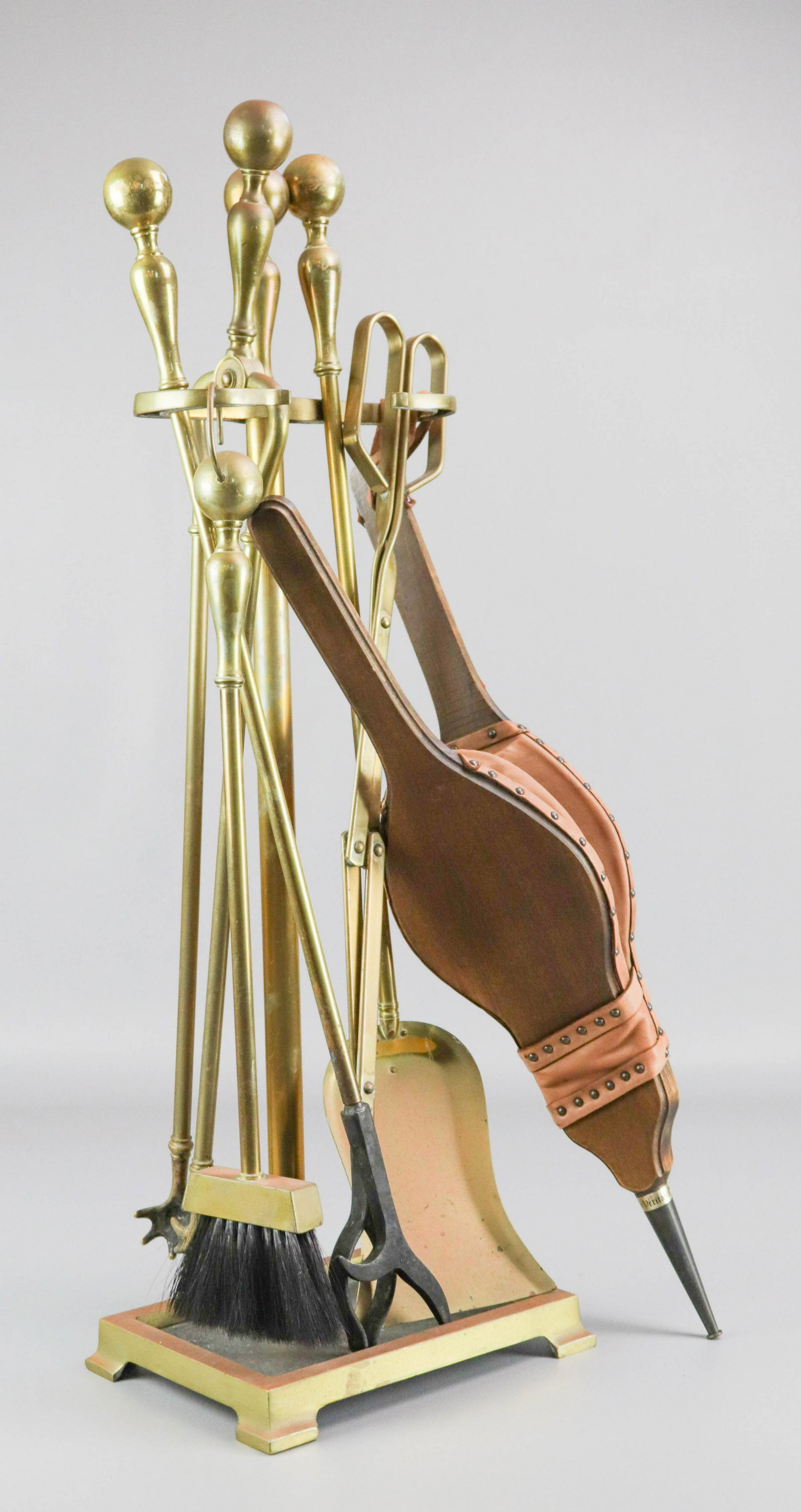 Brass Fireplace Tools and Stand: Brass fireplace tools and stand to include baluster and ball handle broom, tongs, shovel and poker. Also included wood and leather bellows.