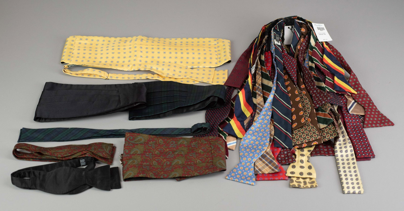 (30) Silk and Wool Bow Ties: (30) Silk and wool bow ties to include Polo, Brooks Brothers, J. Press, Drake's, Paul Stuart and more. Also to include (4) bowties with matched cumberbund.