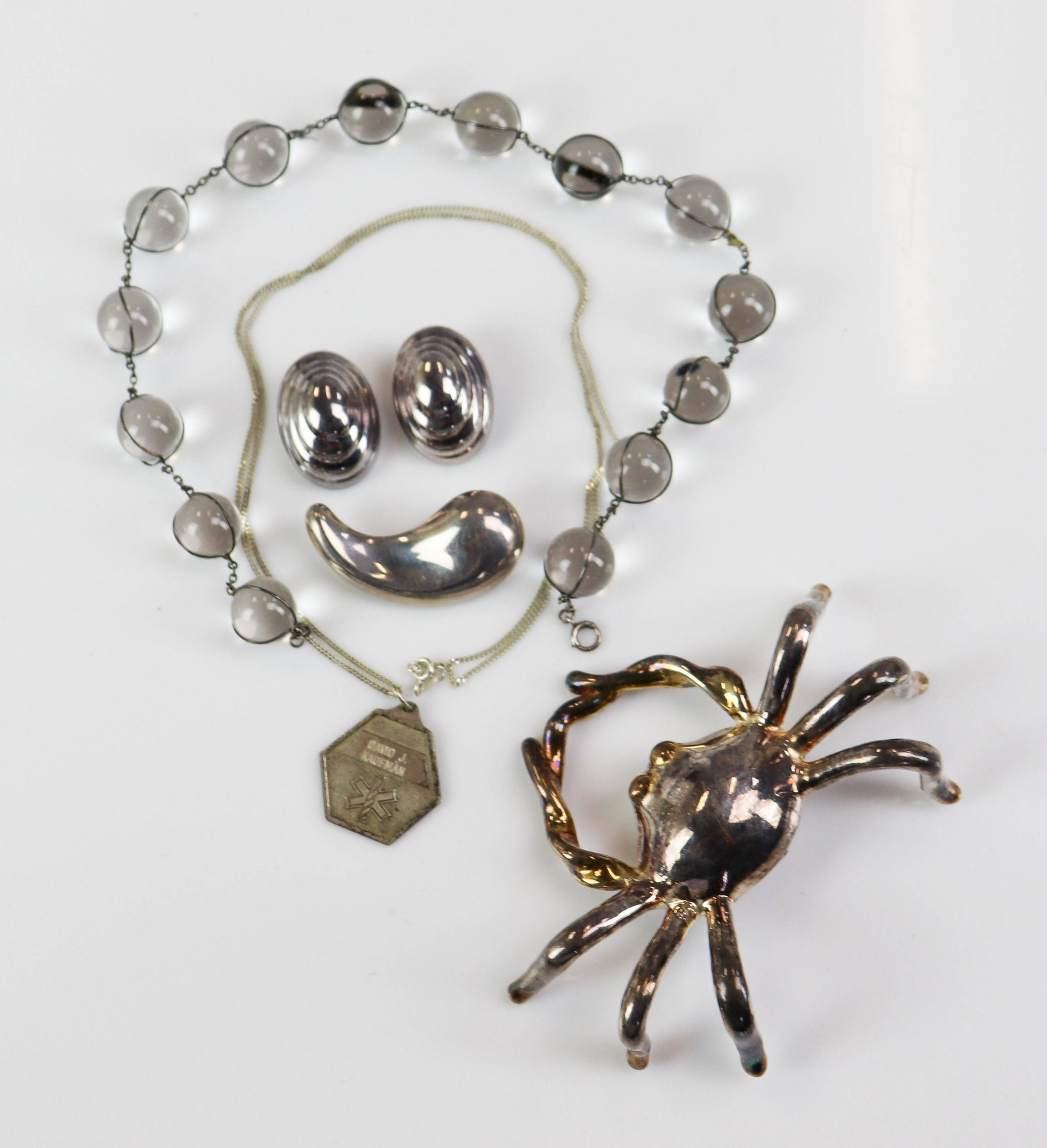 Sterling Silver and Tiffany Lot: (1) pair of sterling silver non-pierced clip earrings signed "italy" 925 (1) Paloma Picasso Tiffany 925 free form pin, (1) 24" long chain and medical alert pendant, (1) large crab brooch, marked 925, 