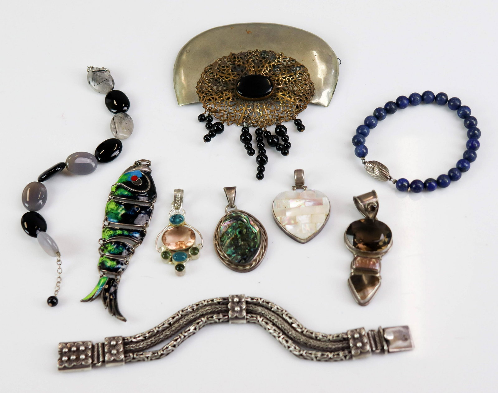 Sterling Silver Charms and Pendants: (3) sterling silver bracelets, one braided turkish style links, one lapis bead bracelet, one black and purple beaded stone bracelet. Five Pendants, (1) Made in Mexico mosaic heart, (1) Shell pendant, 
