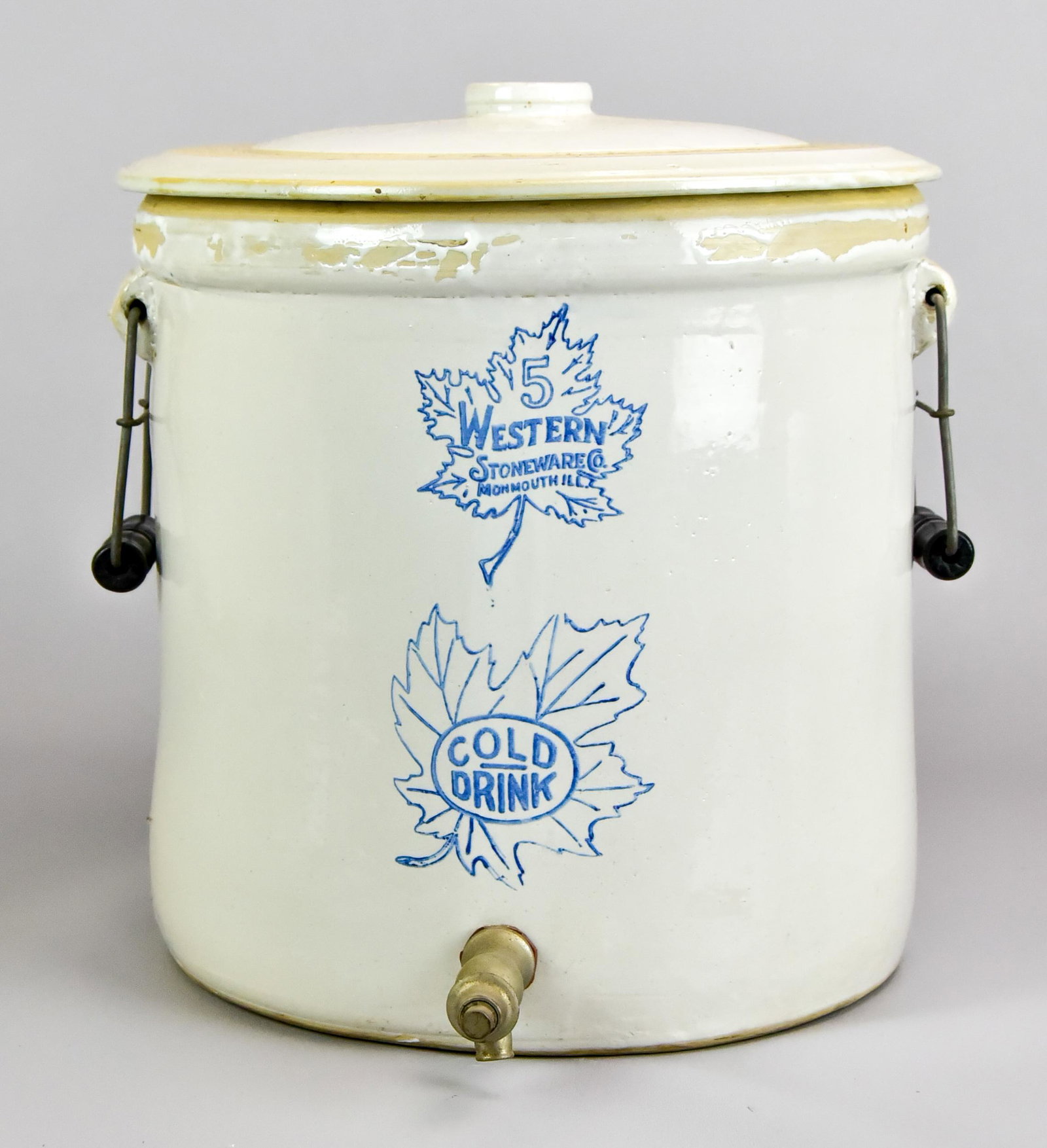 Western Stoneware Cold Drink Cooler: Western Stoneware cold drink cooler, dispenser nozzle, double handles at sides, with handled cover, 13" diam x 12-3/4" h, Chip to interior rim underside of lid. No other chips or cracks.