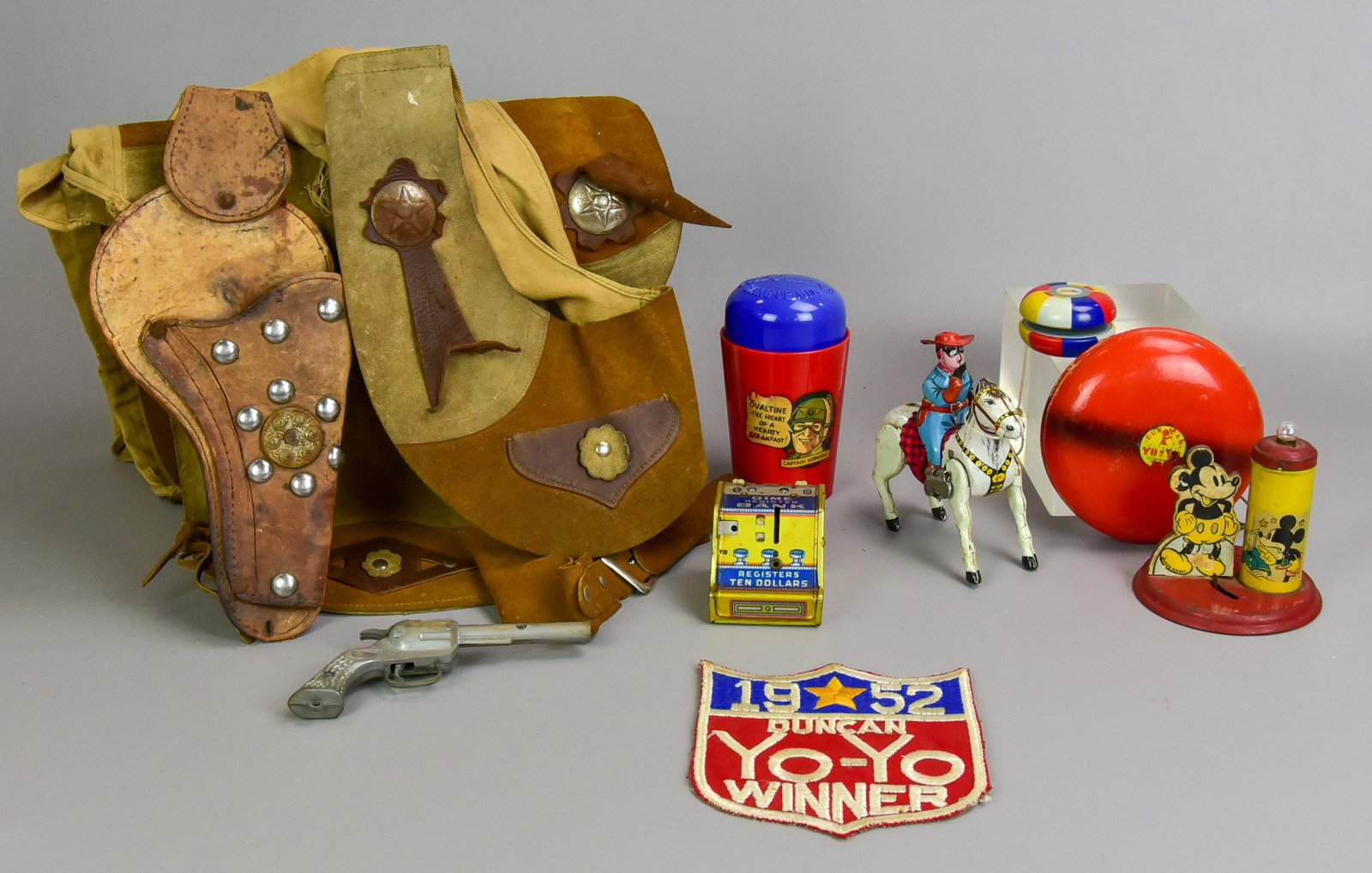 Childs Cowboy Costume, Tin Toys: Childs cowboy costume, tin toys to include leather childs chaps and vest, incl PAL toy gun, large 1952 Duncan Yo-Yo winner patch, (2) vintage yo-yo's, tin litho lone ranger, functioning, missing tail,