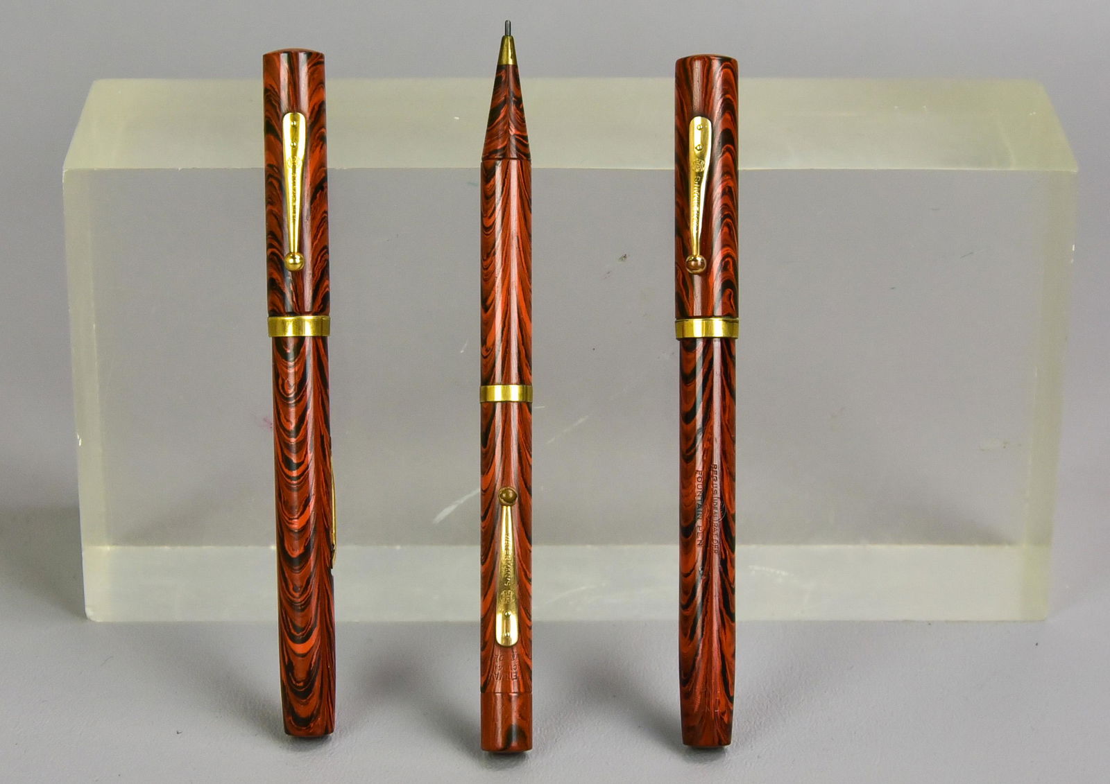 (3) Red Ripple Waterman's Ideal Pens and Pencil: (3) Red Ripple Waterman's Ideal pens and pencil to include (1) Waterman's Ideal mechanical pencil, Pat. Oct 14 1924, 5-5/8" L and (2) Waterman's Ideal fountain pens, (1) with iridium nib and 'Samuel T