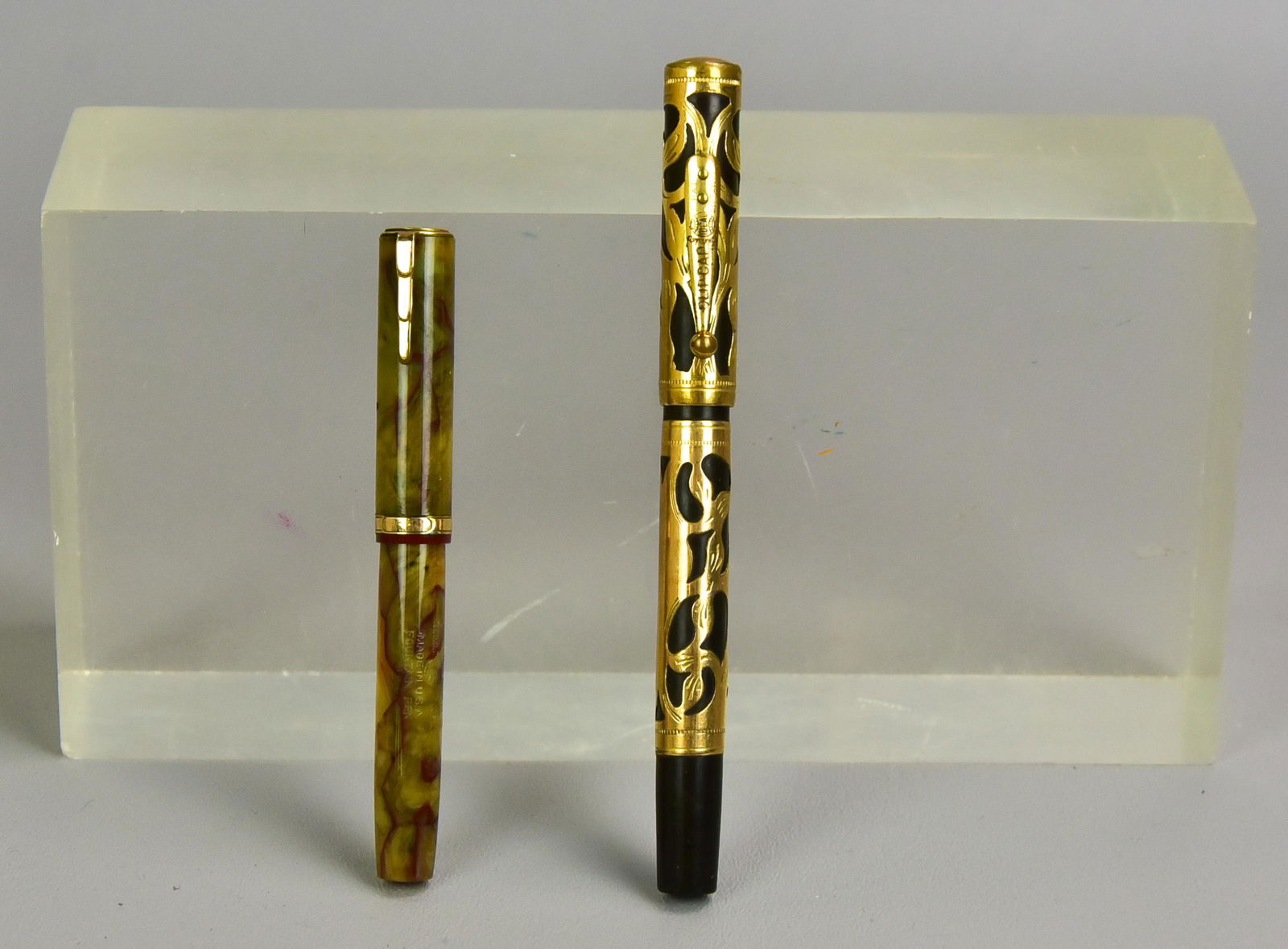 (2) Waterman's Fountain Pens: (2) Waterman's fountain pens to include agate colored Lady Patrician fountain pen with Waterman's Ideal 2 nib, 4-1/4" L and Waterman's Ideal Clip Cap gold plated overlay with Waterman's Ideal 2 nib, 5