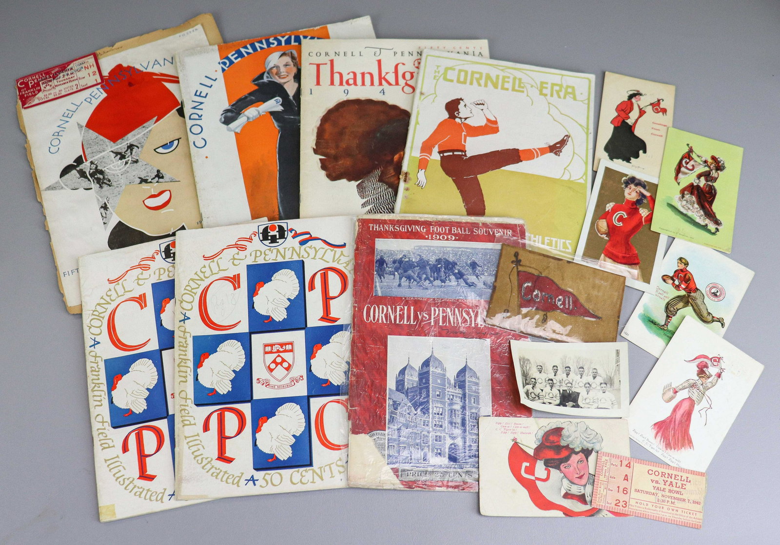 Cornell Ephemera Grouping: Cornell ephemera grouping to include men in varsity sweater photograph, Cornell vs. Pennsylvania Thanksgiving Football Souvenir 1909, Cornell PA at Franklin Field ticket stub attached to Franklin FIel