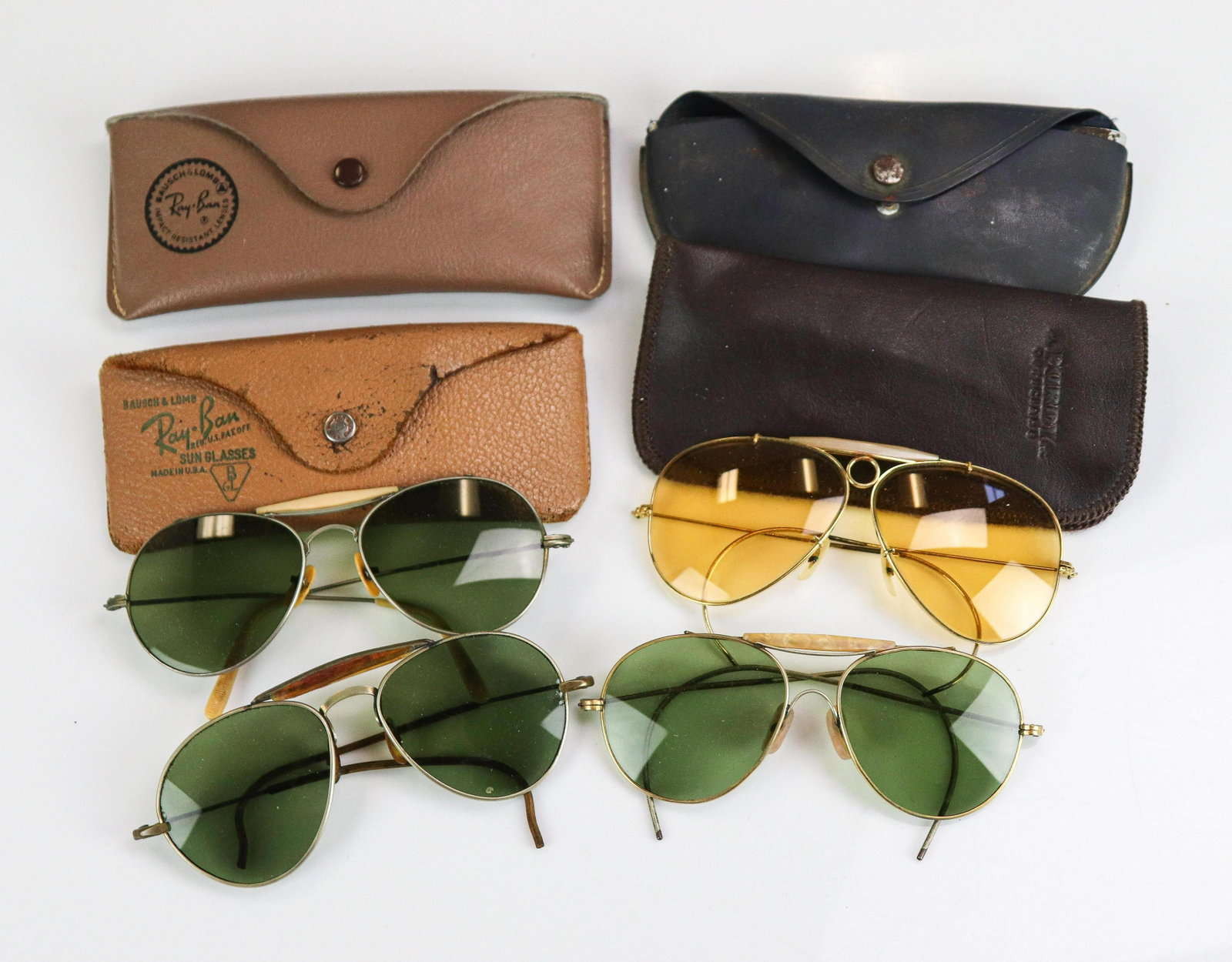(4) Pair Vintage Ray Ban and Style Sunglasses: (4) Pair Vintage Ray Ban and style sunglasses to include Ray Ban Bausch and Lomb Shooter aviator glasses, yellow lenses, cable temples and (3) Outdoorsman style glasses, green glass lenses. Incl. asso