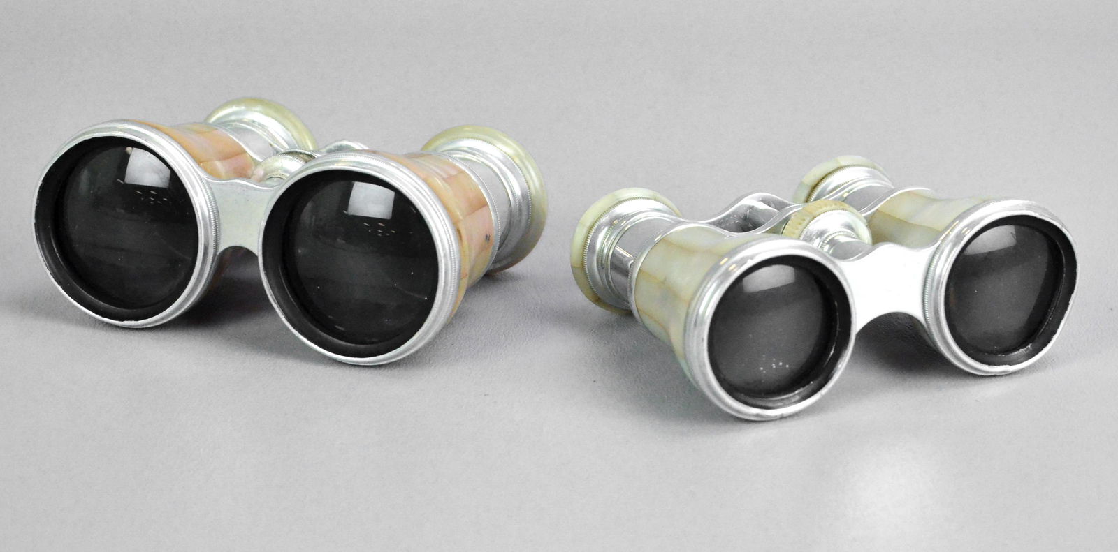 (2) Pairs Le Maire Paris Opera Glasses: (2) Pairs Le Maire Paris opera glasses, both MOP clad with brand engraved eye mounts, silver tone bodied and adjustable.