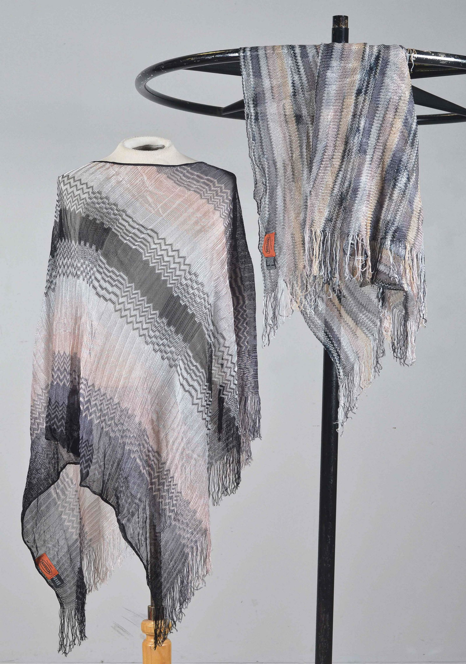 (2) Missoni Shimmer-Stripe Fringed Ponchos: (2) Missoni shimmer-stripe fringed ponchos incl. tan, peach, blue and grey shimmer striped poncho with partial fringe surround and chevron stripe woven blue, black and pink poncho with partial fringe