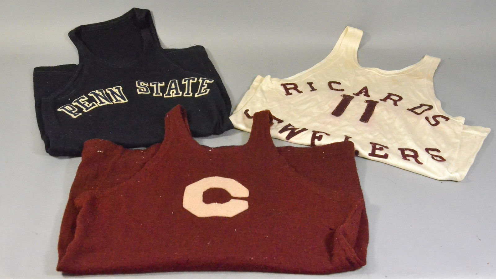 (3) Antique Track Jerseys: (3) 30's/40's Track jerseys to include wool Penn State track jersey, 'C' wool comprised track jersey with moth bites and business funded jersey reading, 'Ricards Jewelers 11'