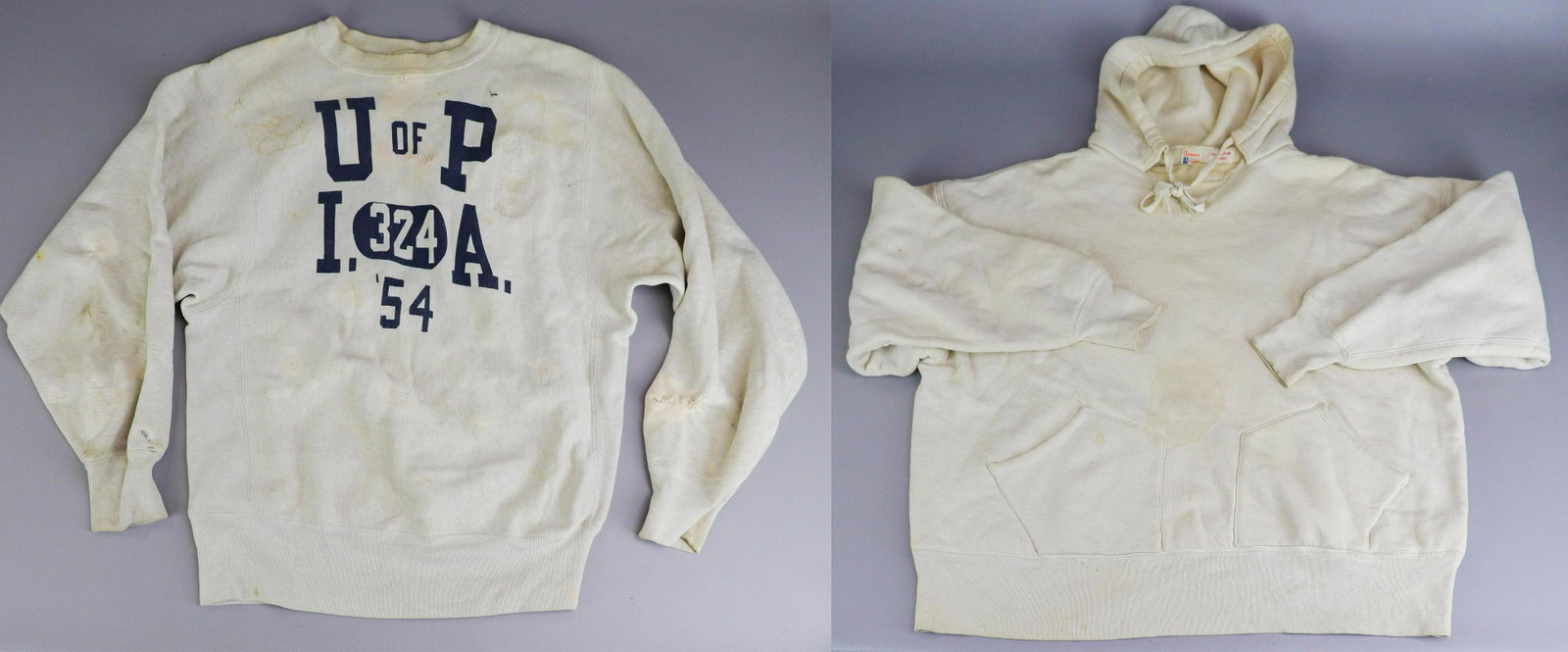 (2) 1950's U of P Champion Sweatshirts: (2) 1950's U of P Champion sweatshirts to include U of P crew neck, '54, several stains, repairs and wear, 40" bust and U of P hooded sweatshirt with double pocket front, '53, stains and wear, 54" che