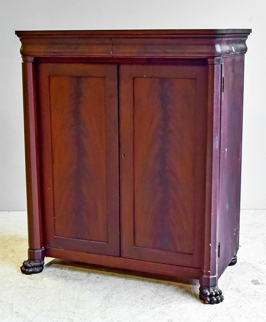 Mahogany Empire Revival linen press, c. 1900.: Mahogany Empire Revival linen press, c. 1900, American, on paw feet, fitted with a pair of ogee molded drawers over cupboard doors concealing linen slides and drawers. OH 56 1/2", OW 45 1/2" OD 24 1/2
