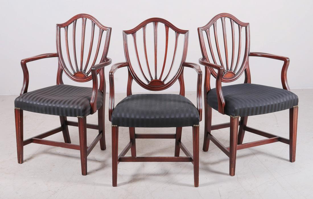 (3) Hepplewhite style mahogany armchairs: (3) Hepplewhite style mahogany armchairs, shield shaped backs, serpentine seat rails, raised on tapered molded legs, with stretcher base, 38-1/2"h, 2 armchairs with cracks at seam on backs, wear to le