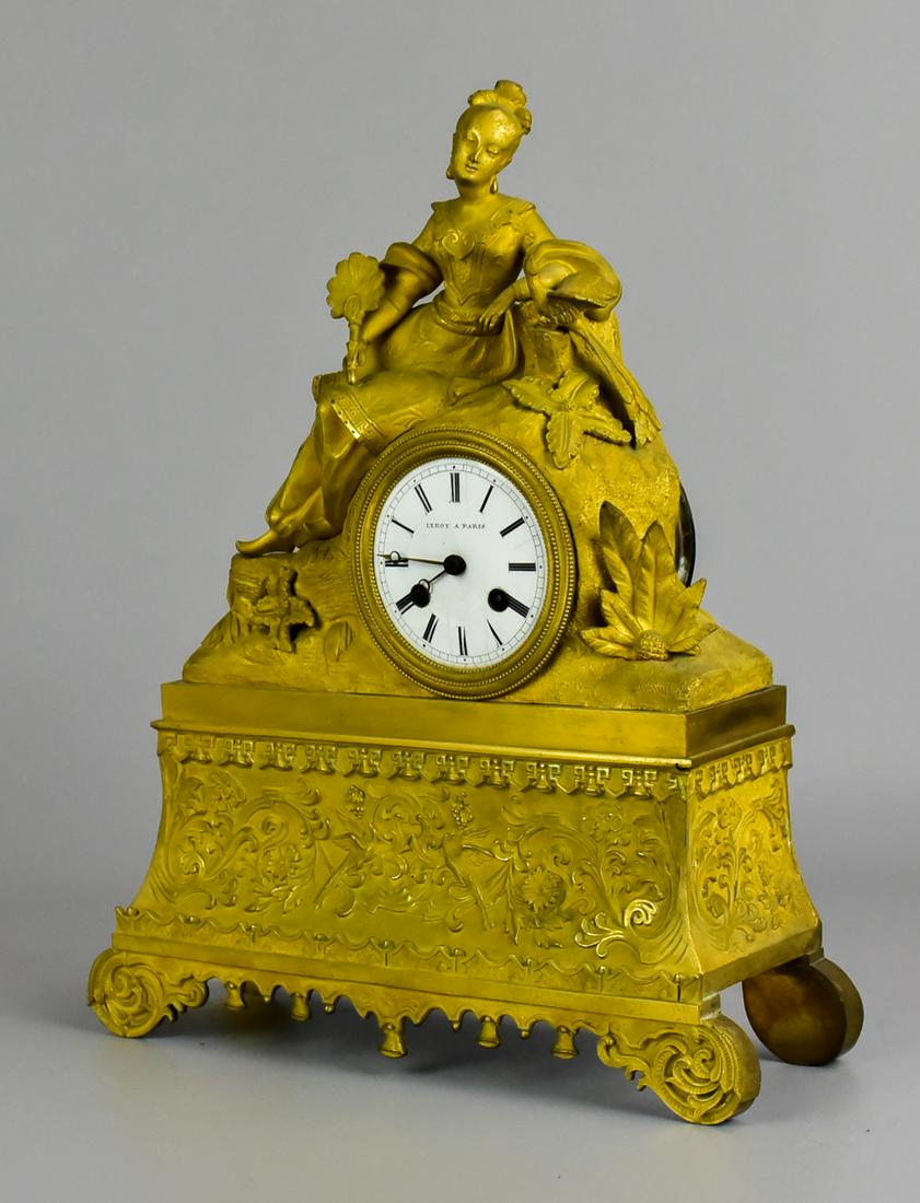 Gilt Bronze French Shelf clock, Leroy a Paris, 14" h: Gilt Bronze Figural French Shelf clock, lady with fan seated with exotic bird, cast bird and floral decoration at base, porcelain dial and movement signed Leroy a Paris, runs and strikes when wound, 1