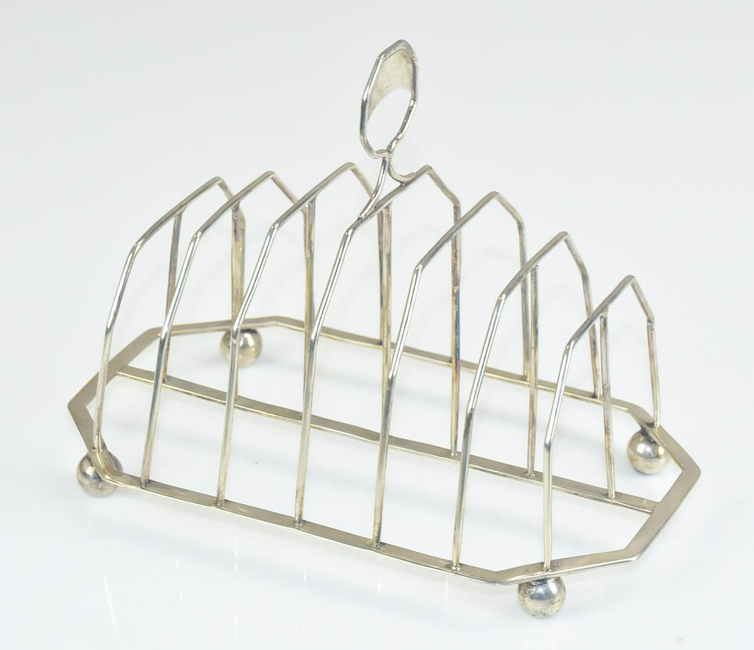 English George III Toast Rack, Solomon Hougham: English George III Toast Rack, Solomon Hougham London, 1787, 7 slot octagonal wire cage form; ball feet, and an octagonal disc handle with an engraved decoration on one side, hallmarked. 5.830 TO, 5.5