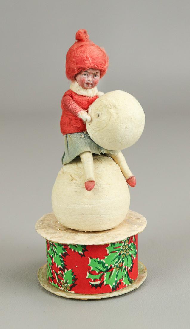 Heubach Girl with Snowball on Candy Container: Heubach girl with snowball on candy container, girl with snowball in spun cotton and paper dress, on snowball, perched atop candy container in holly, berry and shimmer candy container.