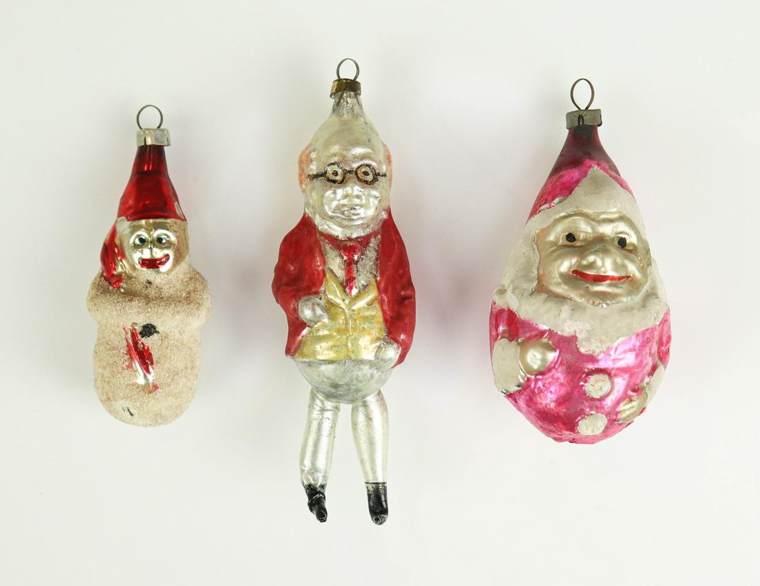 (3) German Glass Ornaments: (3) German glass ornaments to include annealed leg foxy grandpa ornament, wearing glasses with red coat and gold vest, 4-3/4" L, punch clown bust in reddish pink suit and hat, repaired at back, 3-1/2"