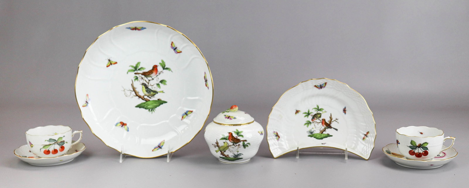 (7) Pcs Porcelain Herend Dinnerware: (7) Pcs porcelain Herend dinnerware to include Rothschild Bird 10" vegetable bowl, crescent salad plate, 8-1/4", covered sugar with strawberry finial, 4-1/2"x4-1/2" and (2) cups and saucers in cherry,