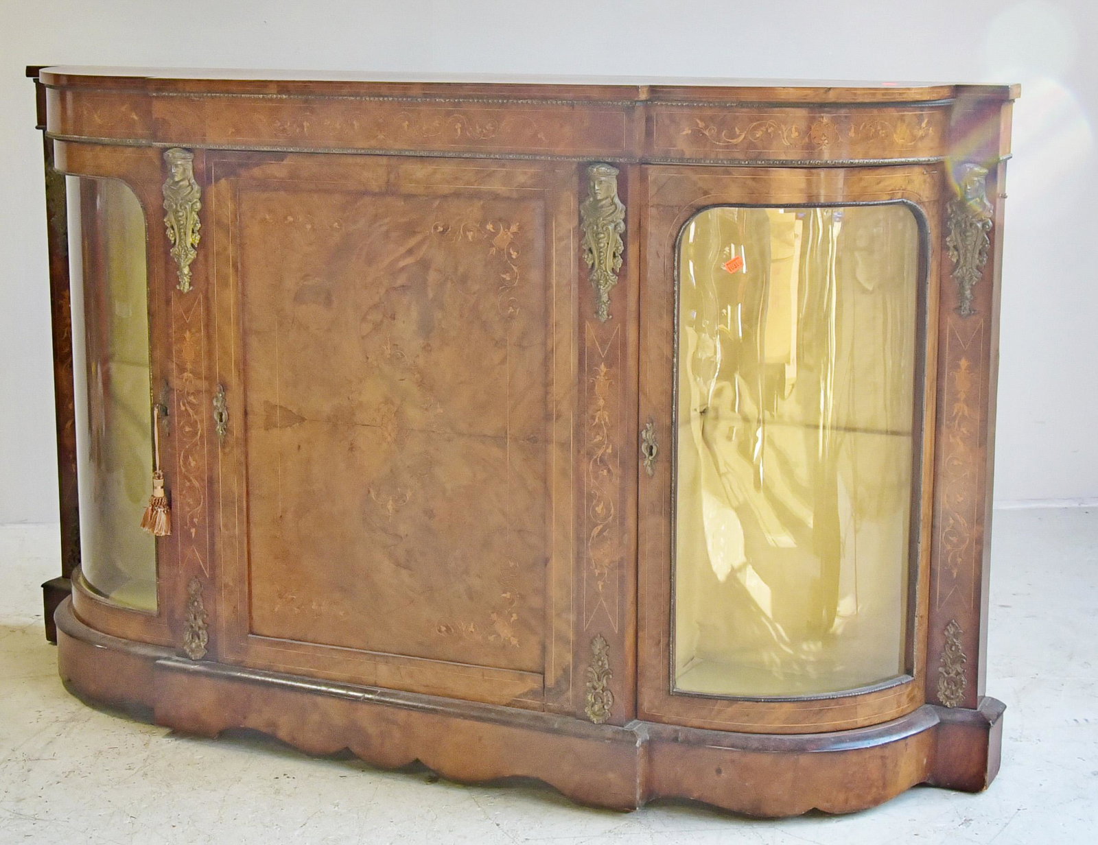 French Empire style inlaid burl walnut credenza: French Empire style inlaid burl walnut credenza center door with bowed glass doors on sides, gilt metal mounts and hardware, 40-1/4"h x 60-1/2"w