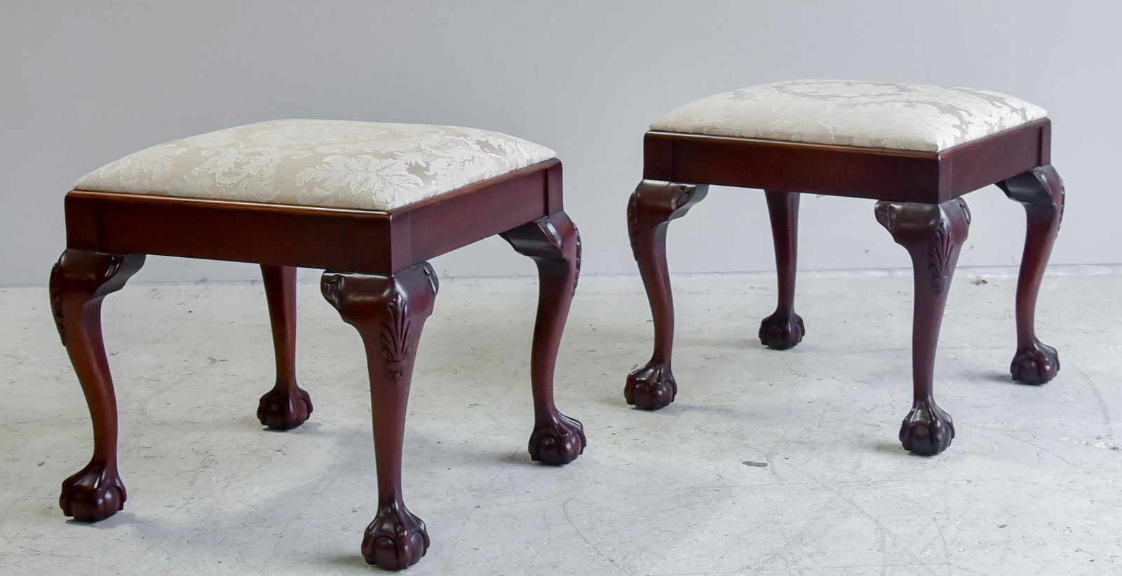Pair of mahogany Chippendale style footstools: Pair mahogany Chippendale style footstools with ball-and-claw feet, OH 17" OW 18 1/2" )D 18 1/2."