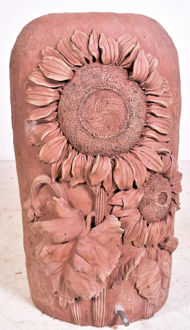Redware sunflower garden pot: Redware sunflower garden pot, small aerator at base, 26"h x 13"diameter, Some hairlines in applied floral decoration, spout at front with oxidation. Some spots of discoloration, small dots almost like