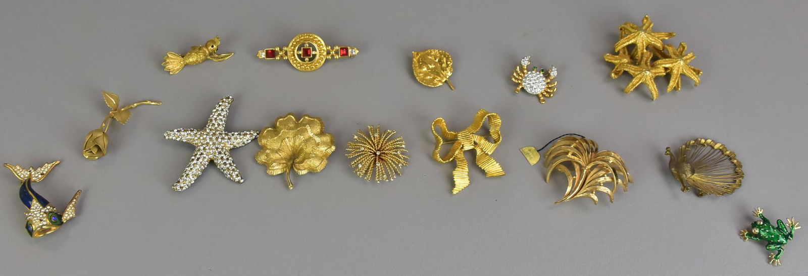 44 pc Lot of Pins and Brooches: 44Pc Lot of Pins and Brooches (43) Pins and Brooches, One signed Trifari with the tag still attached, Talbots and others. (1) sweater Clip and one round monogram clip.